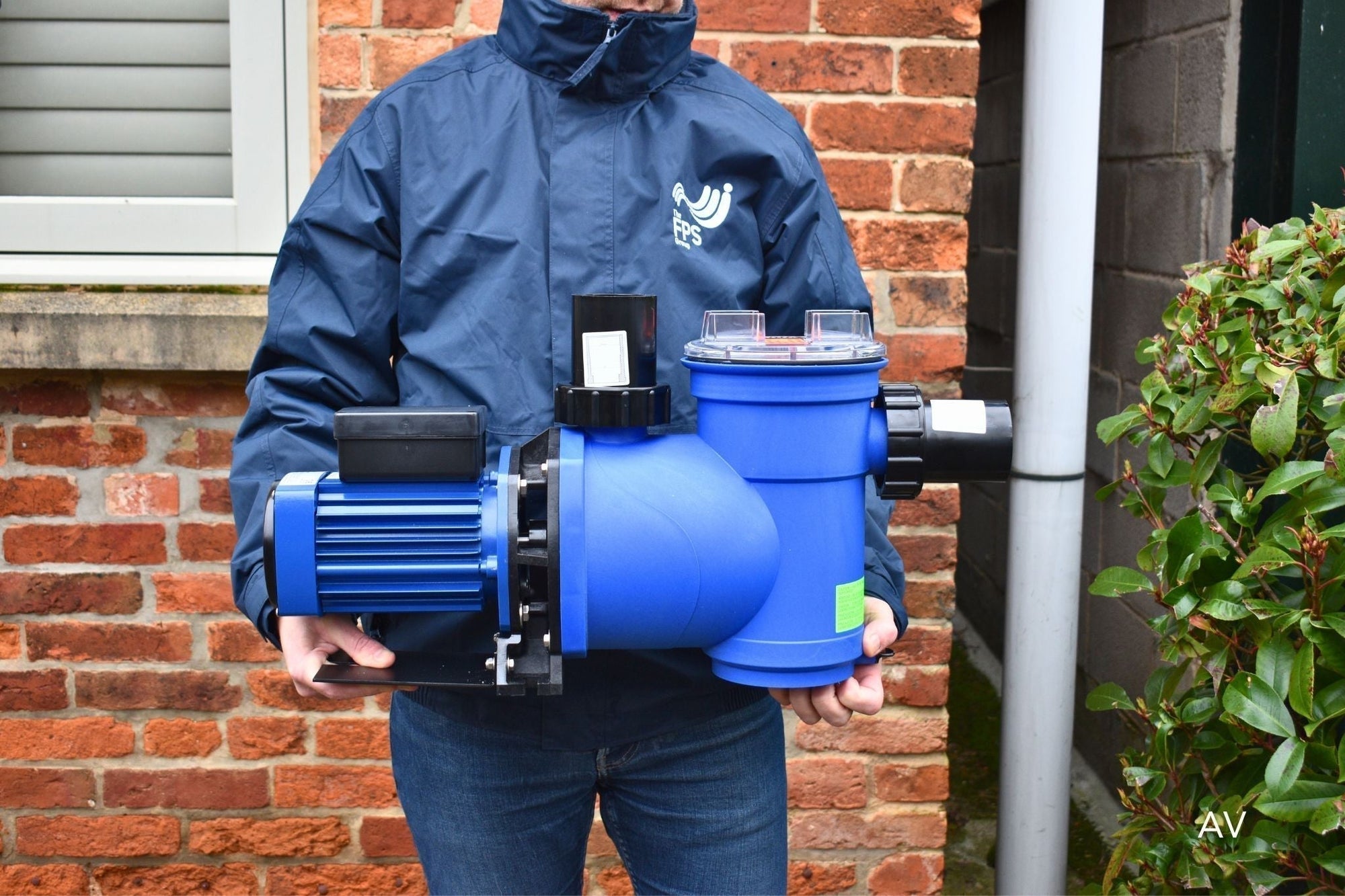 Pump Engineer holding Plastica AV Swimming Pool Pump with FPS Group Jacket on for Flood and Water Pumps