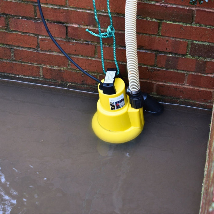 AMA Drainer 301 Submersible Pump pictured in flood water with float arm and hose attached