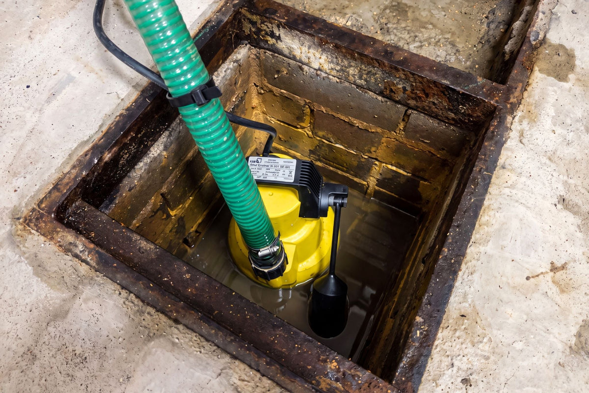 AMA Drainer 301 water pump in a narrow chamber in a cellar