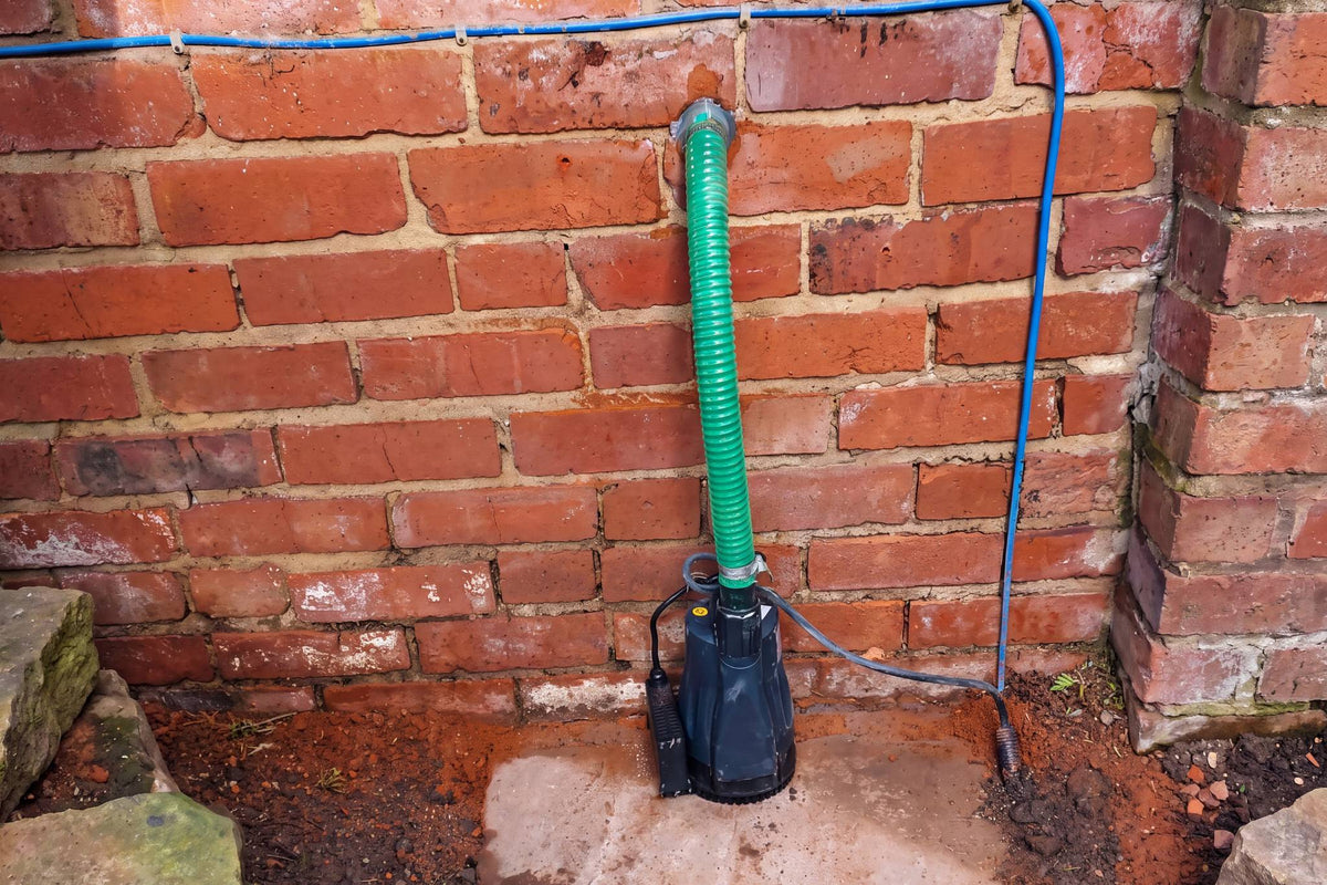 APP RS32EA black pump Installed by garden wall