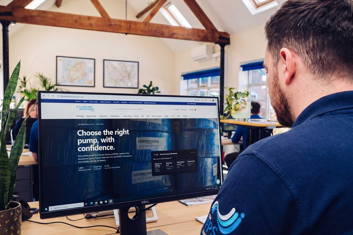 Man in office browsing flood and water pumps website