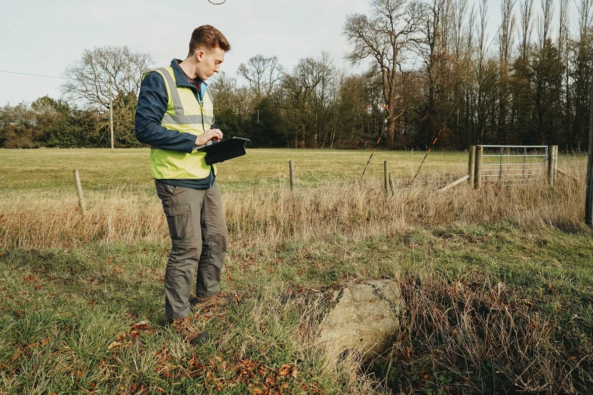 Flood Surveyor reviewing site using ipad