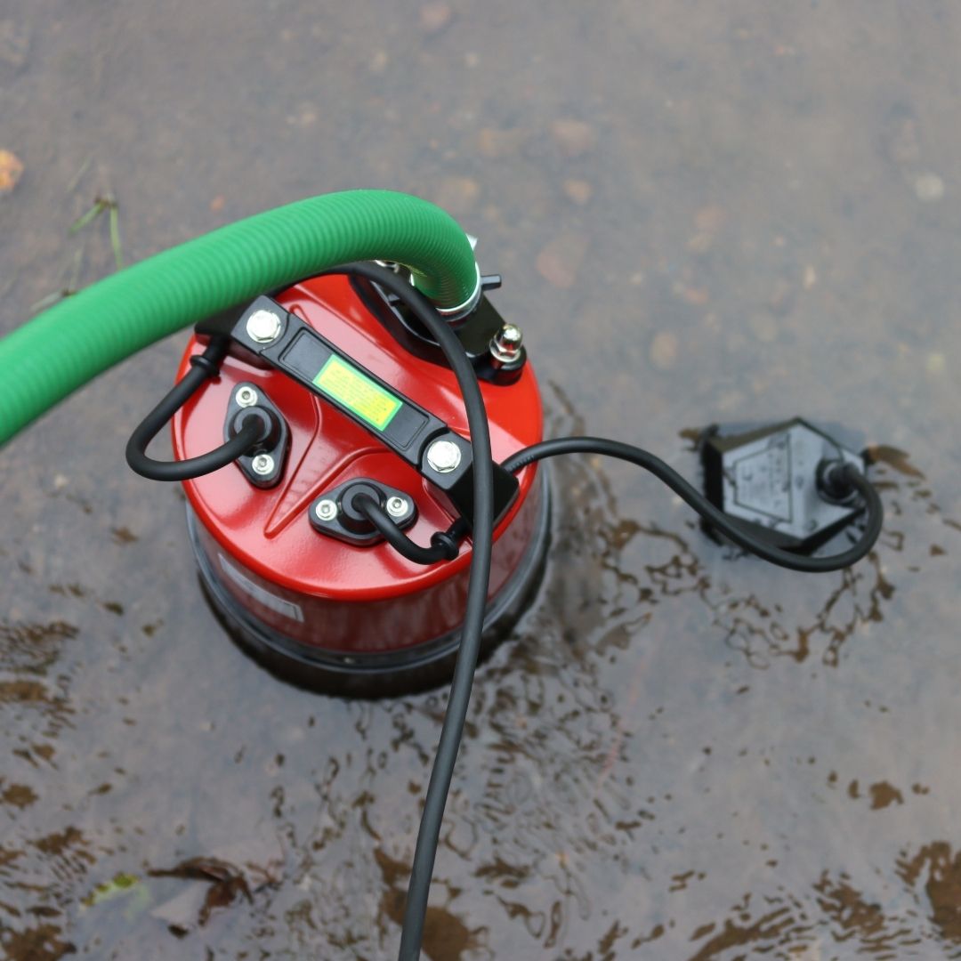 Automatic puddle pump with hose attached