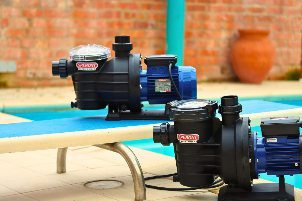 Two Speroni Swimming Pool Pumps on diving board next to a swimming pool