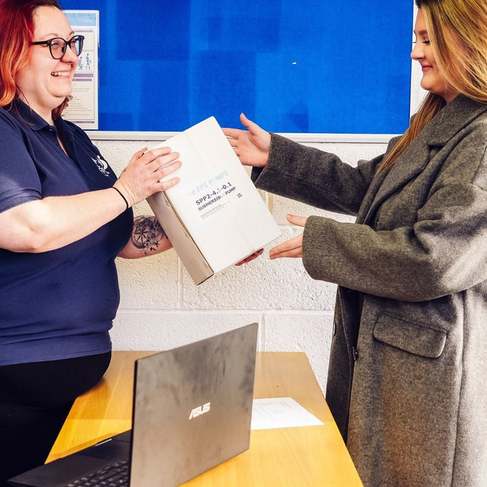 Customer collecting water pump, being handed over from lady
