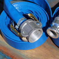 close up of a cam coupling connected to a 25mm lue layflat hose