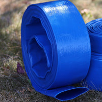 A bright blue rolled-up heavy-duty 50mm layflat hose pipe  