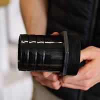 Man holding 80mm hose tail for water pump