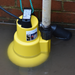 Yellow submersible pump with suction delivery hose