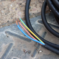 Close-up of electrical wires with colored insulation on a metal surface