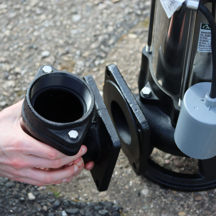 Person shwing vertical fitting on sewage pump