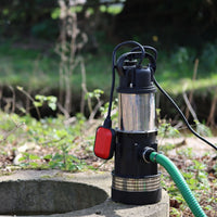 Submersible well water pump with a hose next to a well