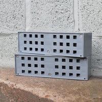 two grey anti flood air bricks stacked on top of each other