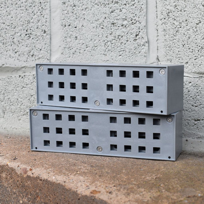 two grey anti flood air bricks stacked on top of each other