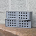 two grey anti flood air bricks stacked on top of each other
