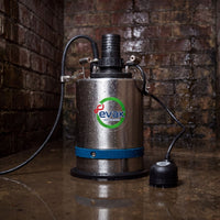A stainless steel Evak water pump with a blue band near the base, a black top connector, and a black power cord, shown on a wet floor against a brick wall background.