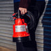 Compact 12V Baby Battery Water Pump held by woman, lightweight and portable for effortless water transfer.