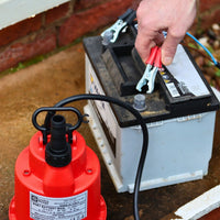 Battery powered water pump being attached to a car battery