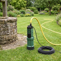 DAB Divertron pump pictured in a garden by a well with hose attached
