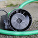 close up of bottom of EGO GI LS puddle pump, suction deliver hose attached 