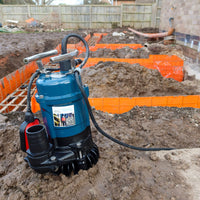 Trenchman drainage submersible pump on a construction site with excavation work.