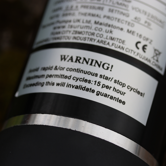 Close-up of a warning label on FL Demand surface water pump