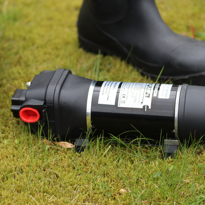 FL Demand surface water pump on grass, black boot in background