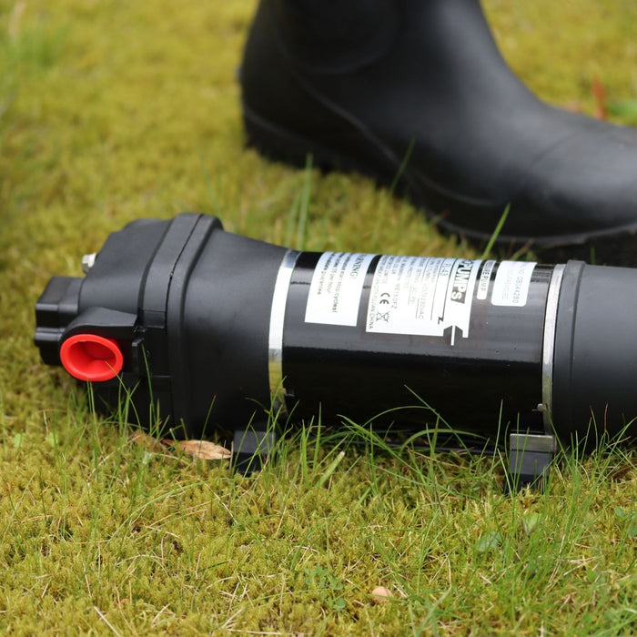 FL Demand surface water pump on grass, black boot in background