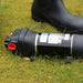 FL Demand surface water pump on grass, black boot in background