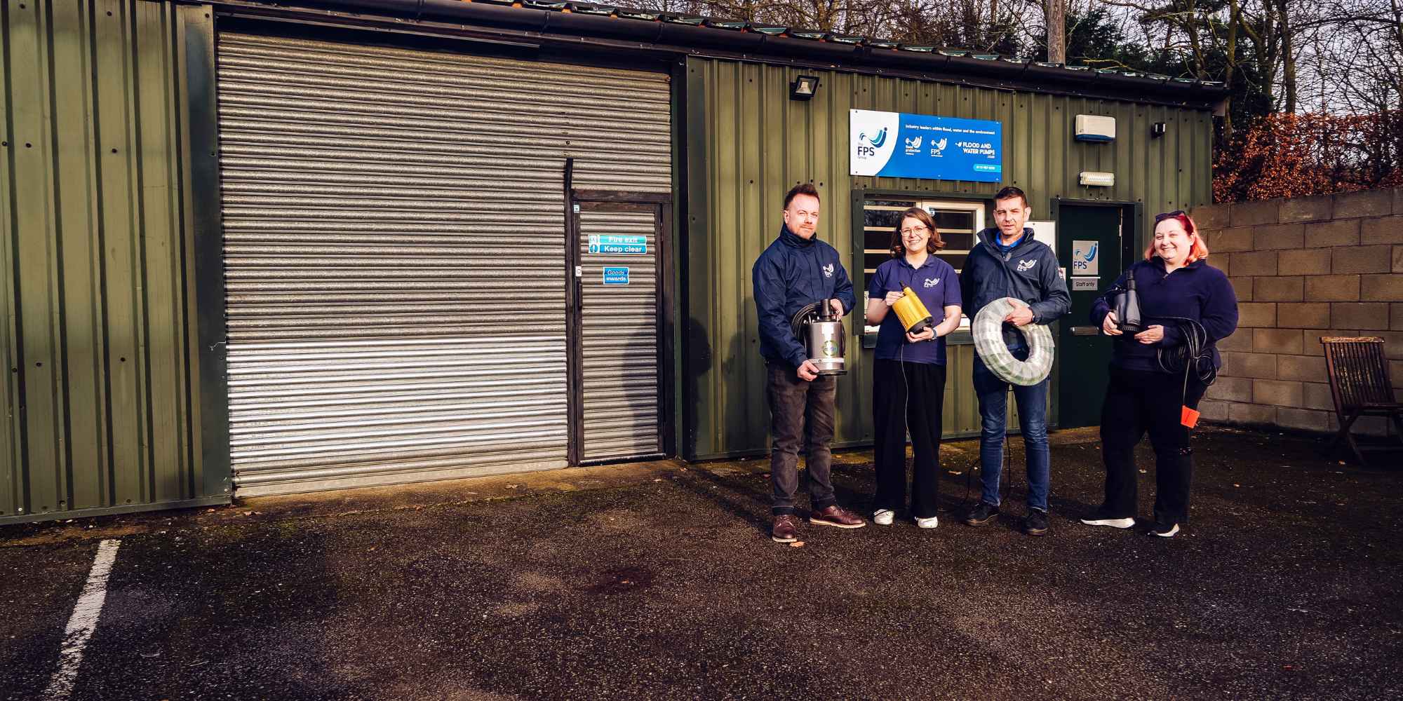 Staff at FPS Pumps warehouse stood holding pumps