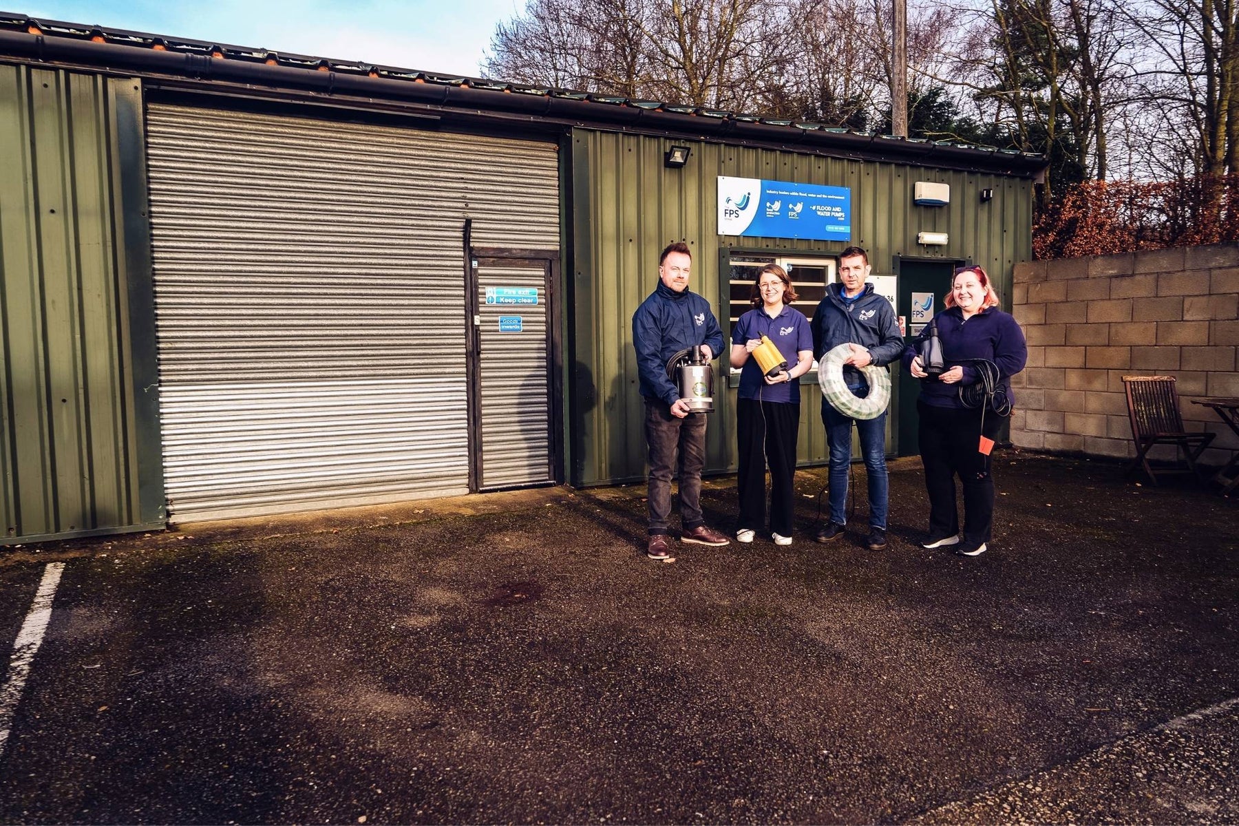 Team of employees stood outside Flood and Water Pumps Warehouse in Nottingham