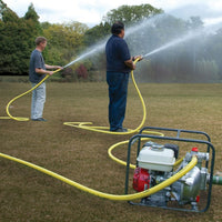 50mm high pressure portable water pump with a yellow hose connected to a petrol pump being used to spray water in an outdoor grassy yard.