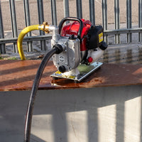 Honda petrol driven water pump with high pressure hose being used to pump water
