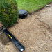 Sump Pump and drain being installed into driveway