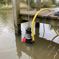 APP MVH Well pump being lowered into a river to power a sprinkler 