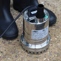 Mizar manual water pump next to wellingtons