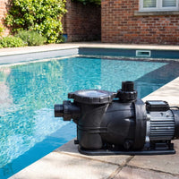 Plastica IFlo Swimming Pool Pump pictured by small garden pool