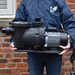 Person holding swimming pool pump