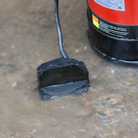 A close-up of a floor sensor on automatic submersible pump sat in flood water