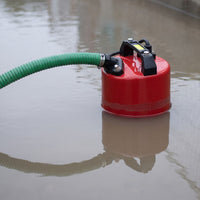 submersible puddle pump sat in flood water, connected to a green suction and delivery hose hose