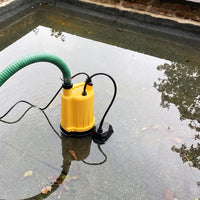 Small automatic floor sensor puddle pump on a flooded flat roof