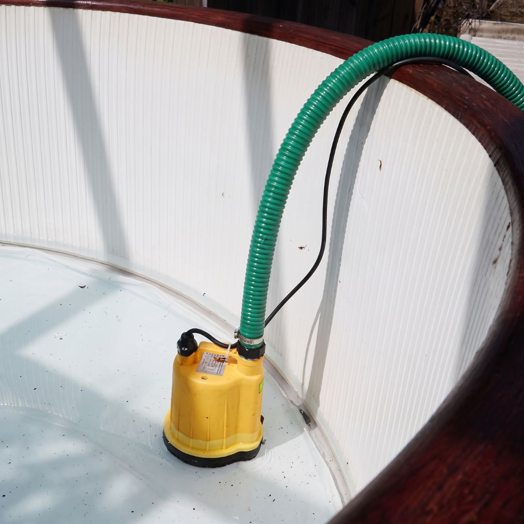 Stream SPP-2 Puddle Pump draining a hot tub. The pump provides a controlled flow rate, making it ideal where water needs to be discharged gradually to a drain, soakaway or garden border without overwhelming the receiving area.