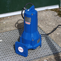 Blue submersible speroni grinder sewage pump on a manhole cover