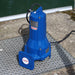 Blue submersible speroni grinder sewage pump on a manhole cover