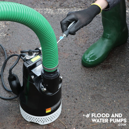 Person attaching a hose to a 110v SPK450A Site Drainage Pump with automatic float
