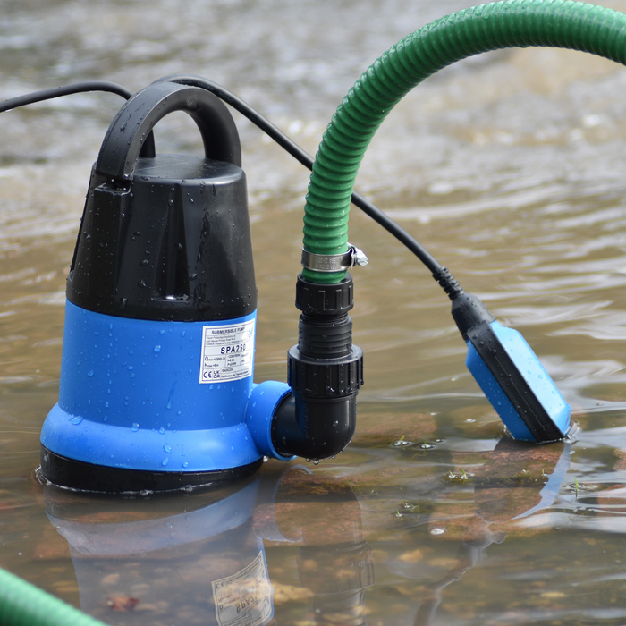 SPA250 submersible pump with a green hose in water