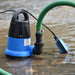 Automatic submersible pump with a green hose in water