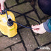 Yellow Stream SPP Puddle Pump positioned on a driveway, showcasing its cost-effective solution as a water pump