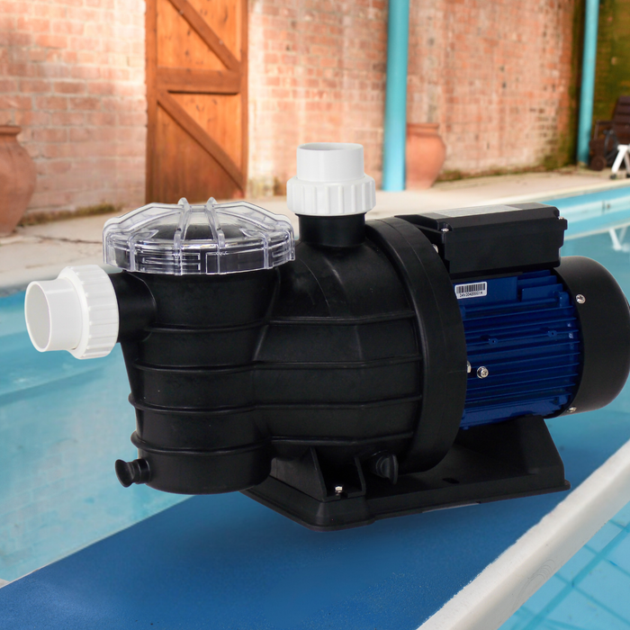 Speroni Swimm Pool pump on the edge of a pool with a brick wall and garden furniture in the background