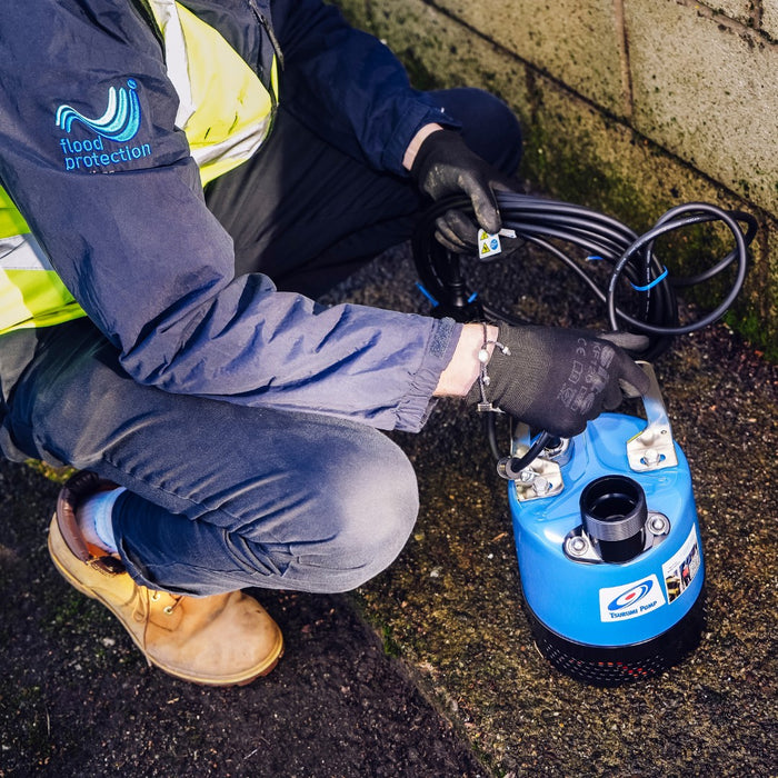Man holding Tsurumi LB submersible site pump